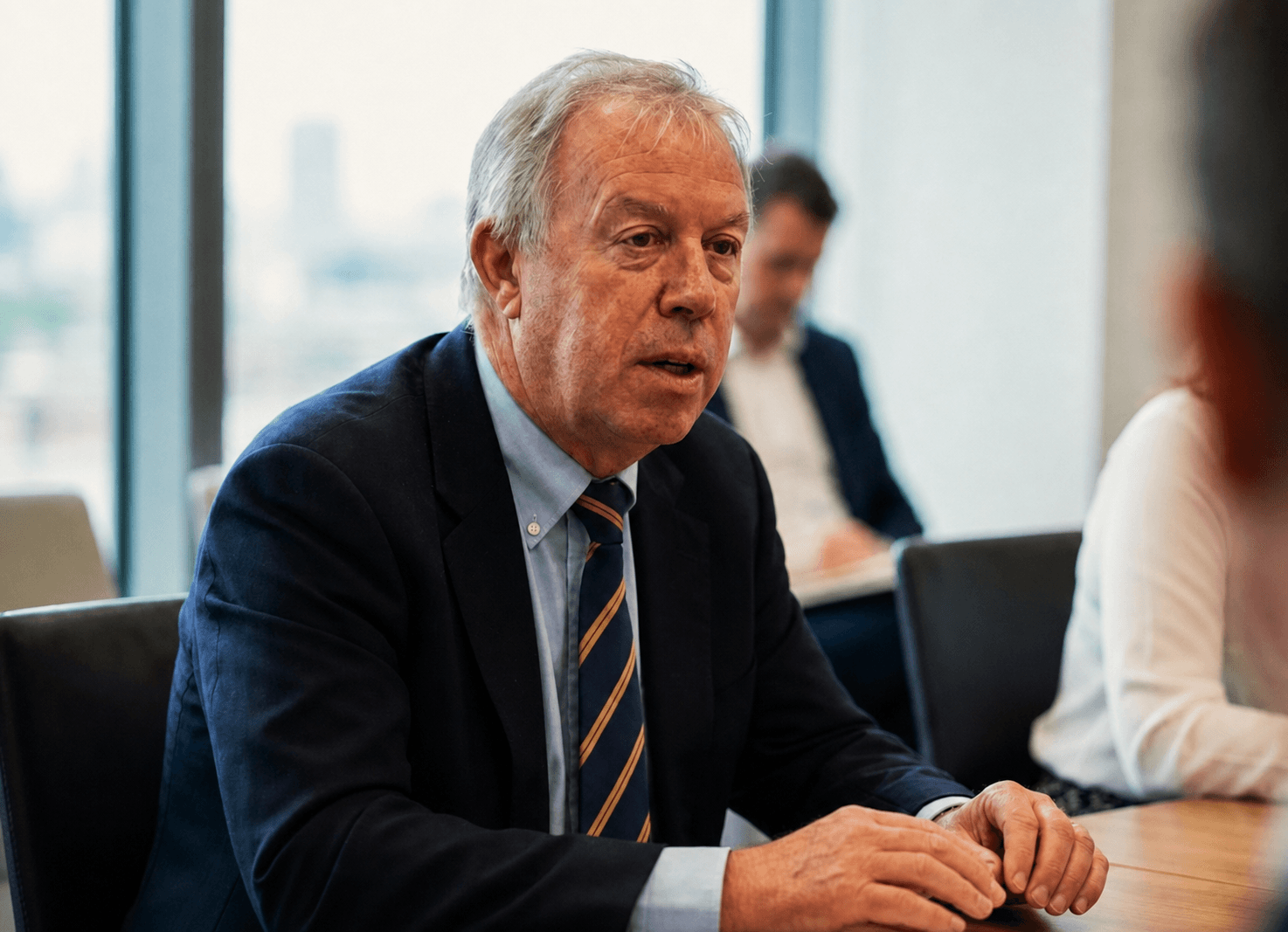Conor O’Connell in conversation with clients around a meeting table